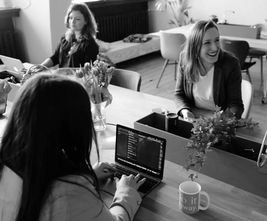 People using notebooks in a desk. This is the desktop version of the image